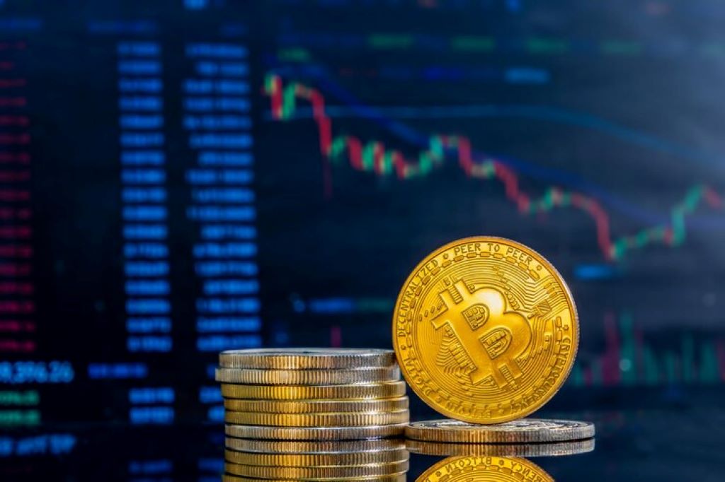 golden bitcoins on a dark reflective surface