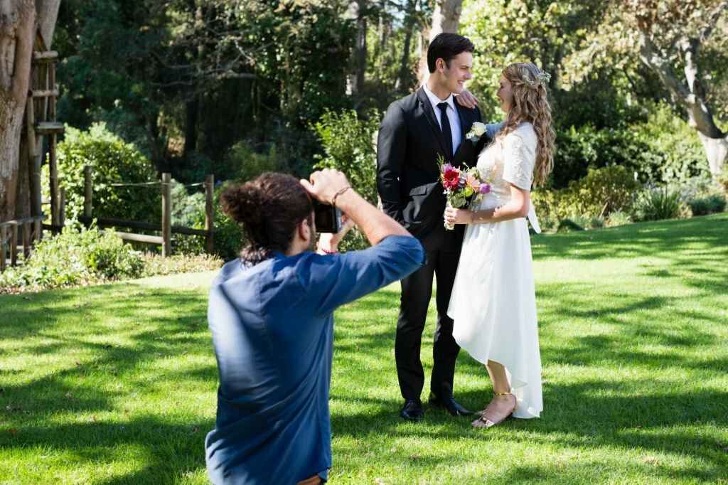 A men taking photos of newly wed